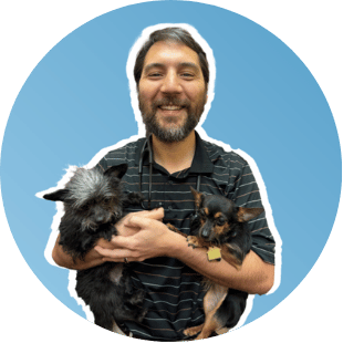 Photo of Dr. Nobuki Stobaeus holding two small dogs